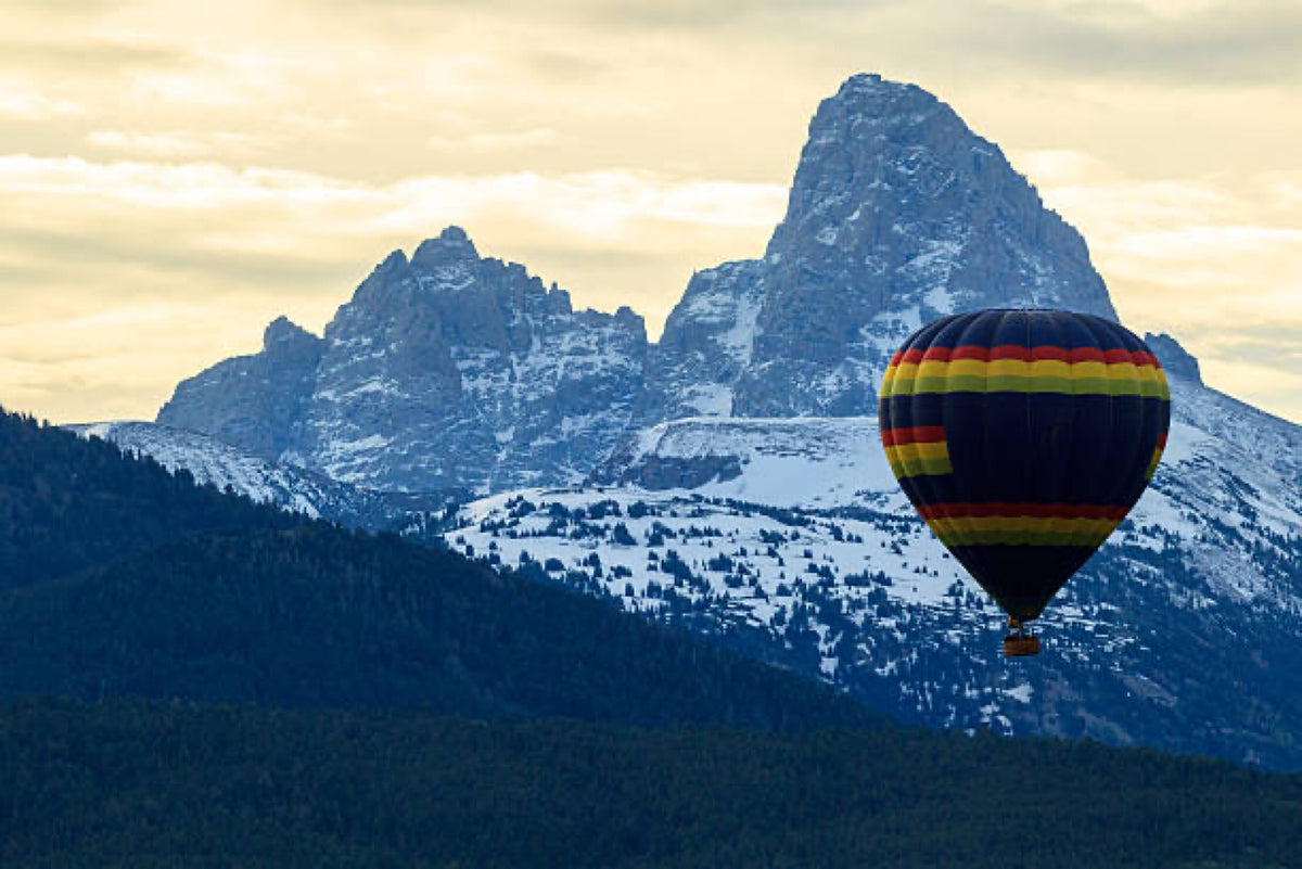 Hot air balloon drifting over the Tetons